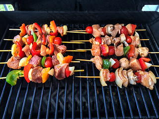 Image showing Outdoor grill with meat and vegetable skewers