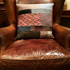 Image showing Leather armchair with decorative cushion