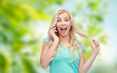 Image showing smiling young woman calling on smartphone