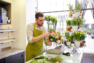 Image showing florist man making bunch at flower shop