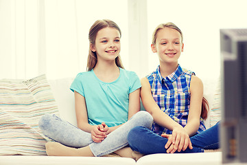 Image showing two happy little girls watching tv at home