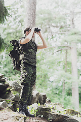 Image showing soldier with binocular and backpack in forest