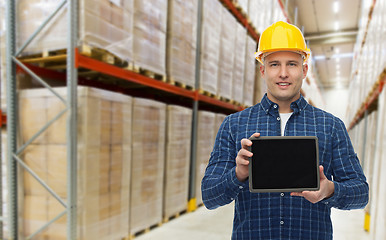 Image showing happy businessman with tablet pc at warehouse