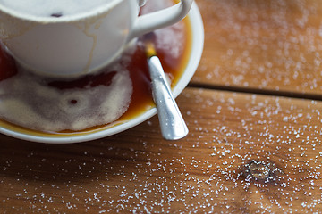 Image showing close up coffee cup and sugar on wooden table