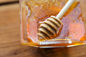 Image showing close up of honey in glass bowl and dipper