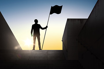 Image showing silhouette of businessman with flag over sun light