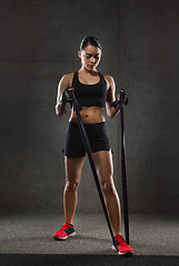 Image showing woman with expander exercising in gym