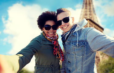 Image showing happy couple taking selfie over eiffel tower