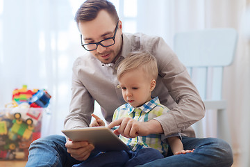 Image showing father and son with tablet pc playing at home