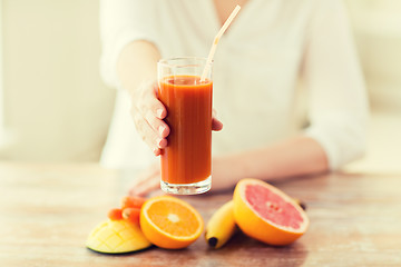 Image showing close up of woman hands with juice and fruits