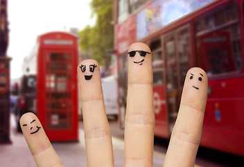 Image showing close up of four fingers with smiley faces