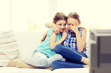 Image showing scared little girls watching horror on tv at home