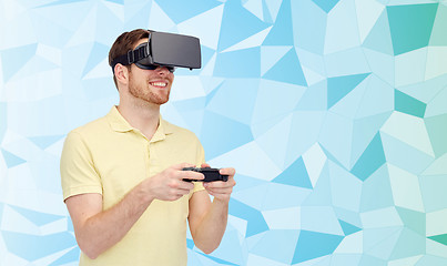 Image showing happy man in virtual reality headset with gamepad