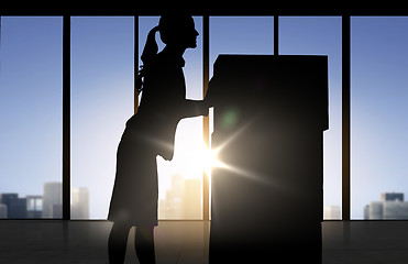 Image showing silhouette of businesswoman moving boxes at office
