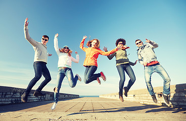 Image showing smiling friends in sunglasses laughing on street