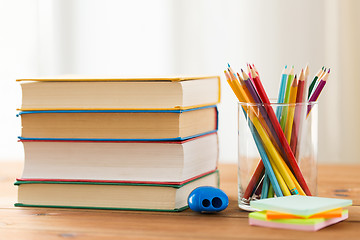 Image showing close up of crayons or color pencils and books