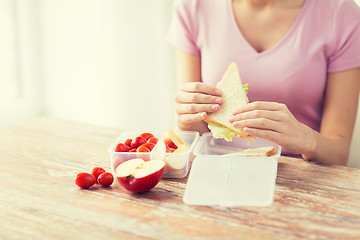 Image showing close up of woman with food in plastic container