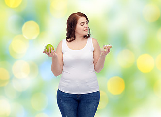 Image showing young plus size woman choosing apple or cookie