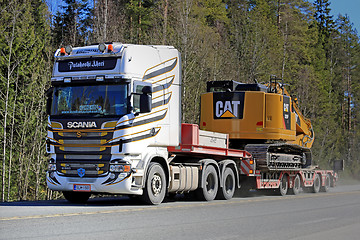 Image showing Scania Semi Hauls CAT Hydraulic Excavator