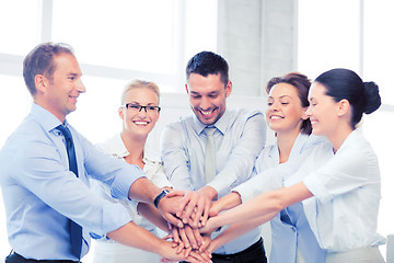 Image showing business team celebrating victory in office