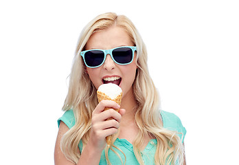 Image showing happy young woman in sunglasses eating ice cream