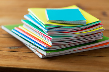 Image showing close up of notebooks on wooden table