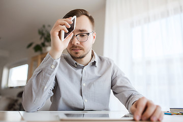 Image showing businessman with smarphone at home office