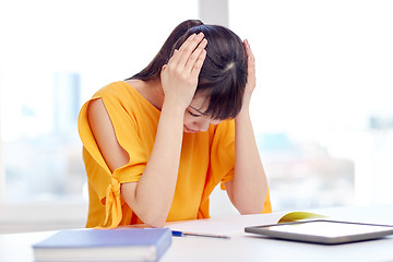 Image showing stressed asian young woman student at home