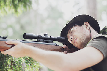 Image showing young soldier or hunter with gun in forest