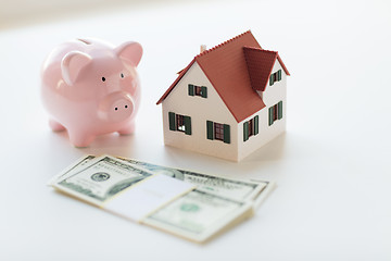 Image showing close up of house model, piggy bank and money