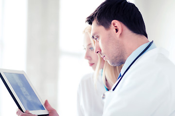 Image showing two doctors looking at x-ray on tablet pc