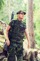 Image showing young soldier or hunter with gun in forest