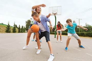 Image showing group of happy teenagers playing basketball