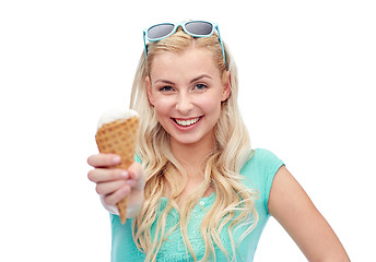 Image showing happy young woman in sunglasses eating ice cream