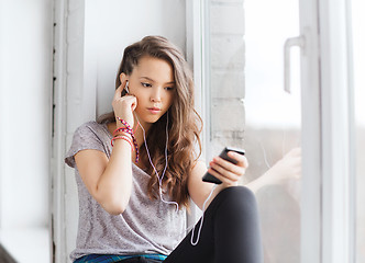 Image showing teenage girl with smartphone and earphones