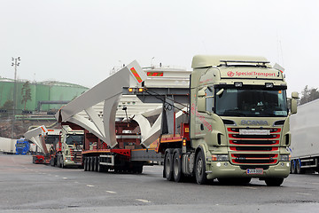 Image showing Two Scania Trucks Haul Long Industrial Object 