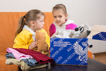 Image showing Volgograd, Russia - February 24, 2016: Two girls were talking collecting clothes and toys in the original Russian mail box