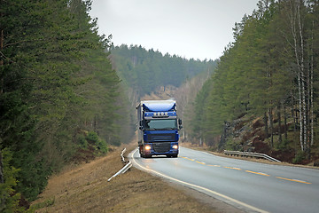 Image showing Blue Semi Truck on Forest Highway