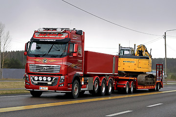 Image showing Red Volvo FH16 750 Transports Crawler Excavator in the Evening