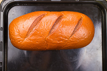 Image showing baking fresh bread in the bakehouse