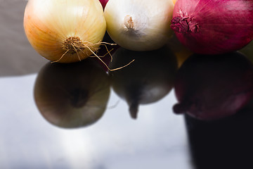 Image showing some onions on a black background