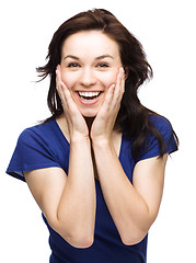 Image showing Woman is holding her face in astonishment