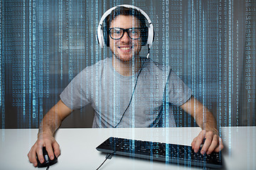 Image showing man in headset playing computer video game at home