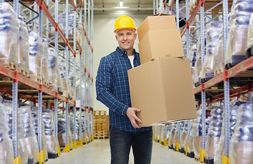 Image showing happy man or loader with box at warehouse