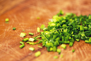 Image showing close up of chopped onion on wooden cutting board