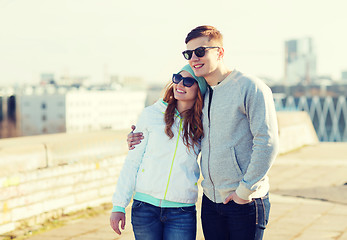 Image showing happy teenage couple walking in city
