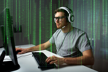 Image showing man in headset playing computer video game at home