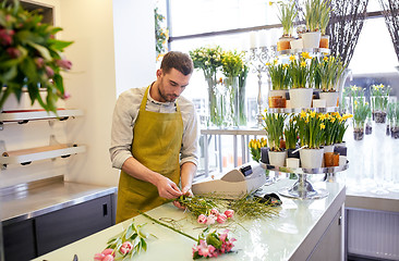 Image showing florist man making bunch at flower shop