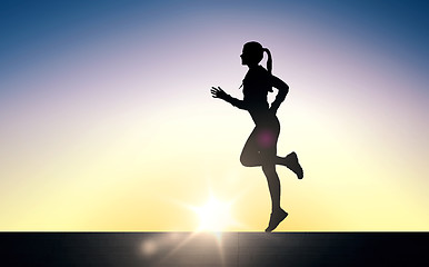 Image showing happy young sports woman running outdoors