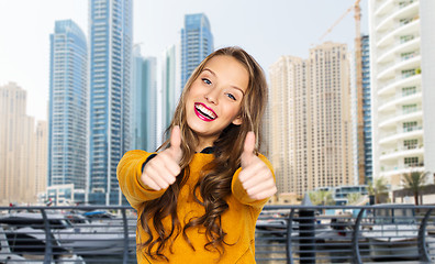 Image showing happy young woman or teen girl showing thumbs up